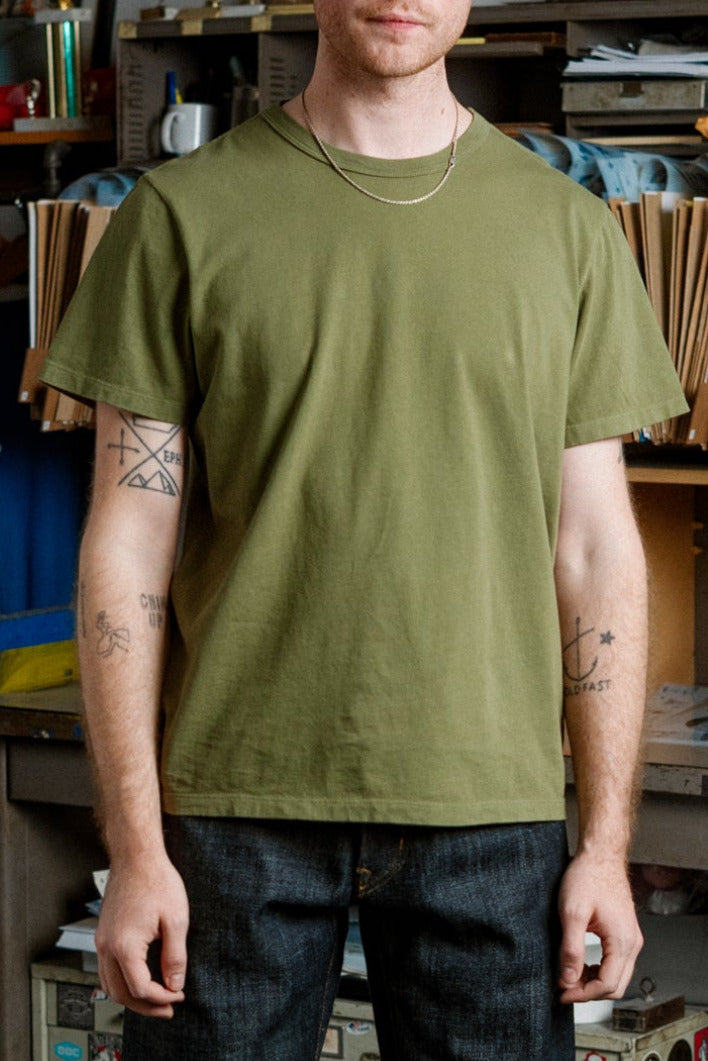 Man standing in a room with shelves and various items