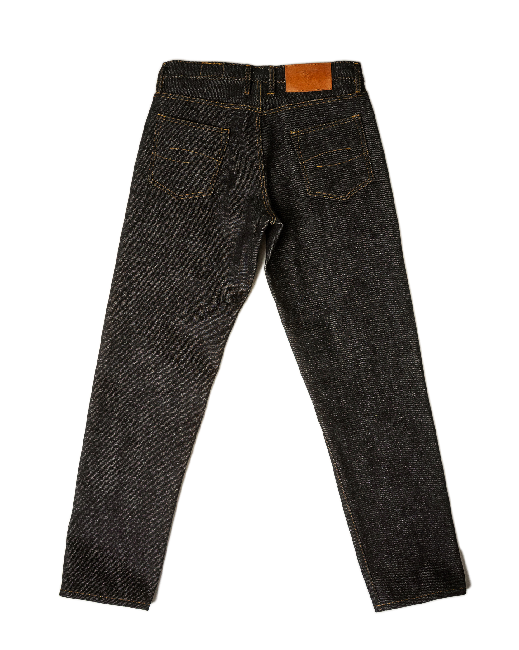 Pair of dark blue jeans on a white background